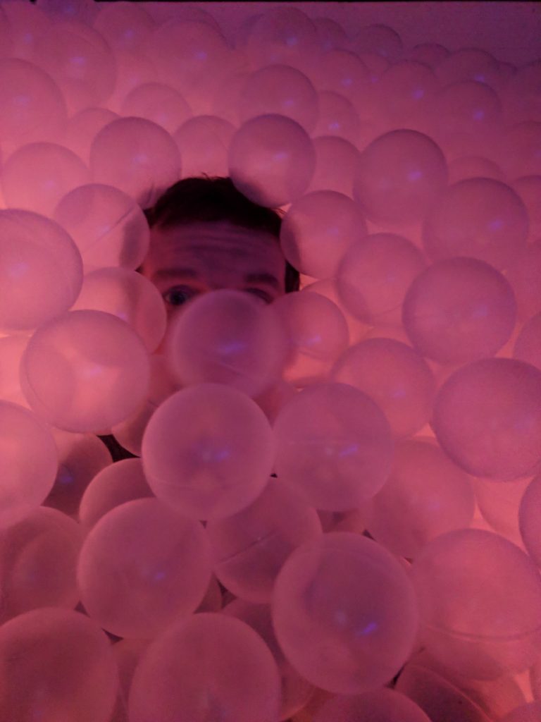 A man inside the ball-pit at Hopscotch, Austin.