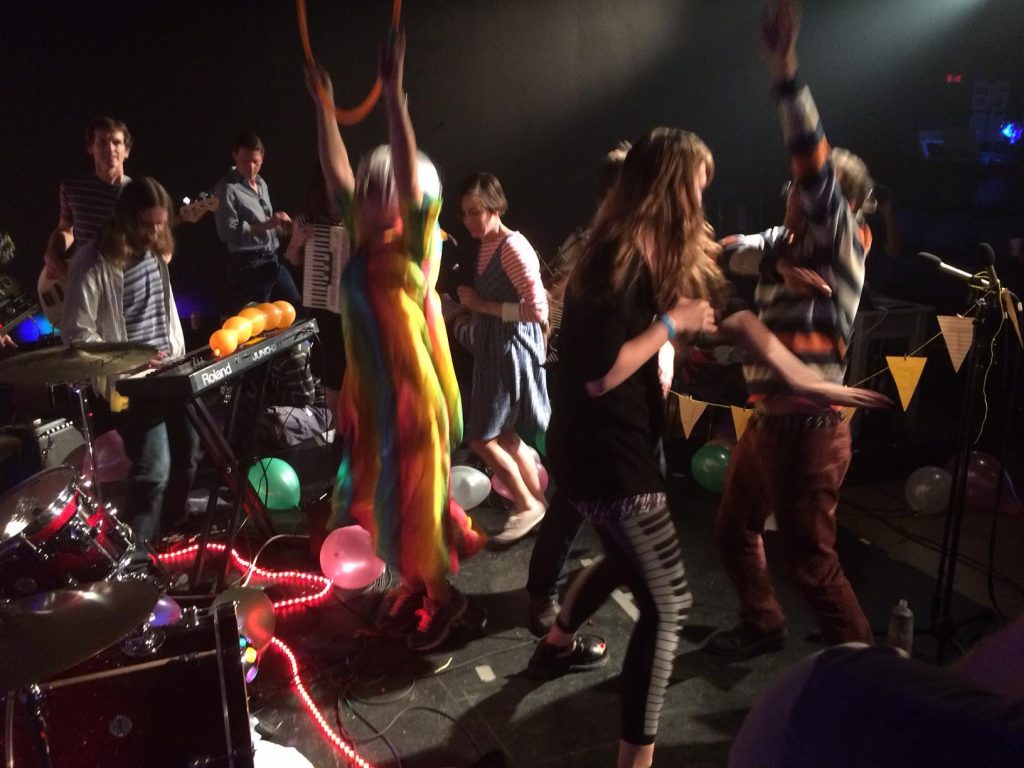 Members of the band 'Ouiness' jamming on stage.